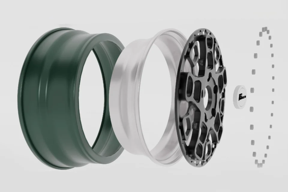 Exploded wheel design showing rim sections, a center disc, and fasteners