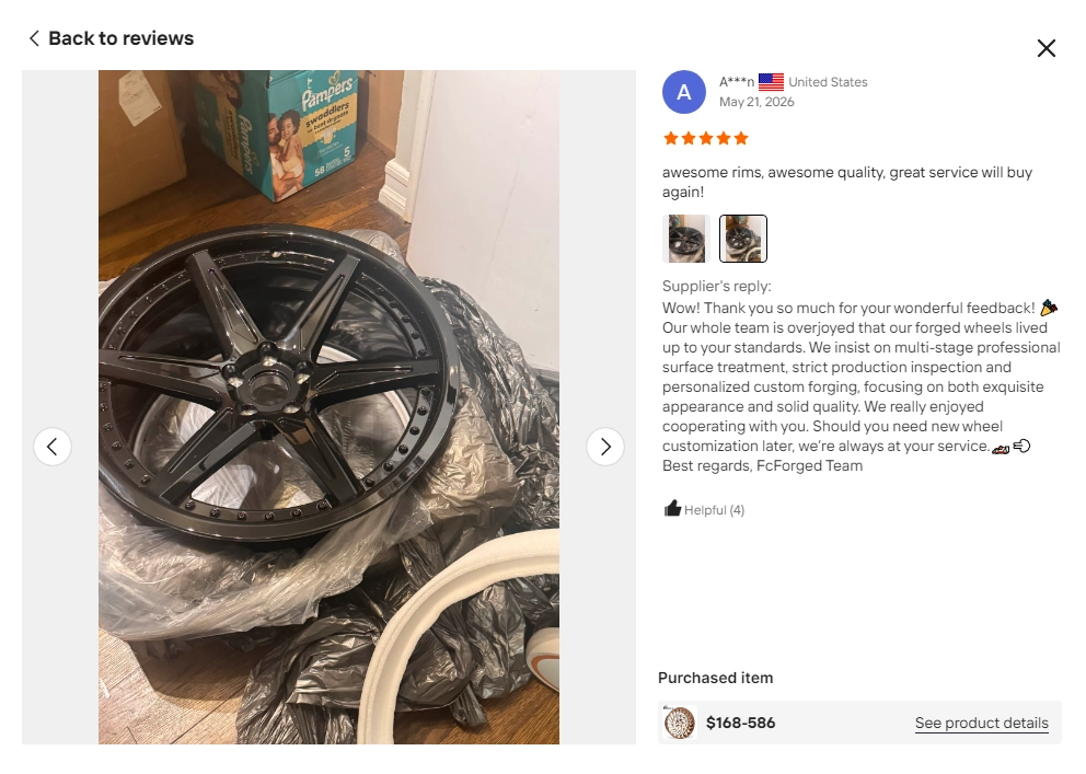 Buyer review screenshot showing an unpacked dark multi-piece wheel