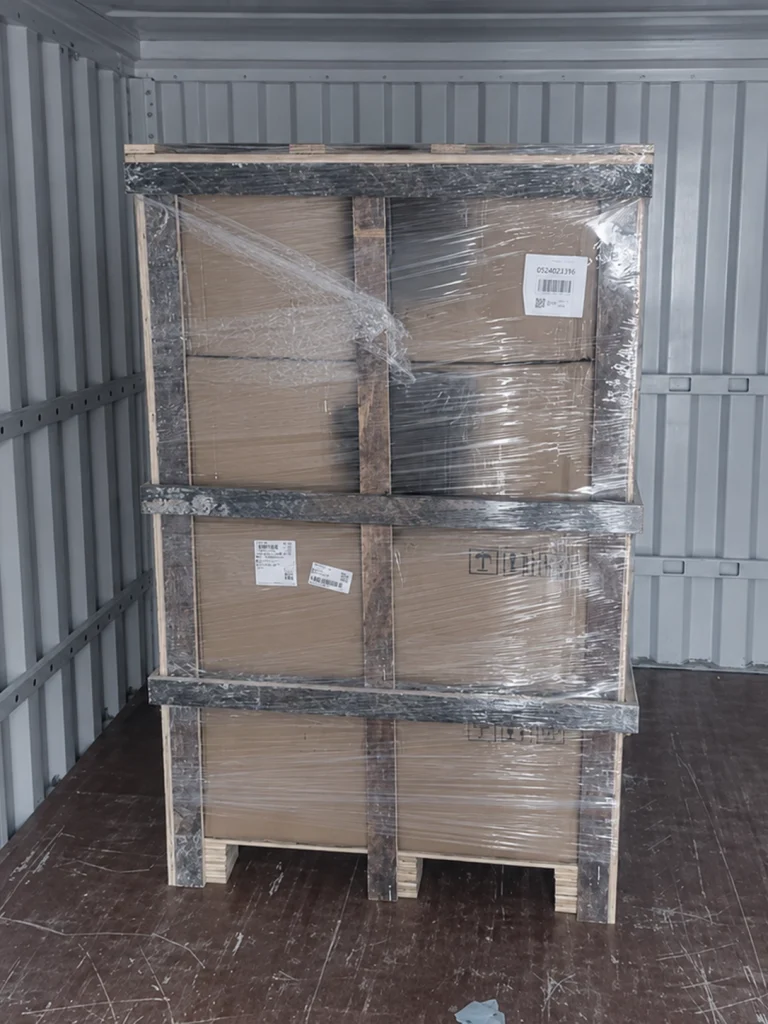 Wrapped and braced wheel cartons on a pallet inside a shipping container