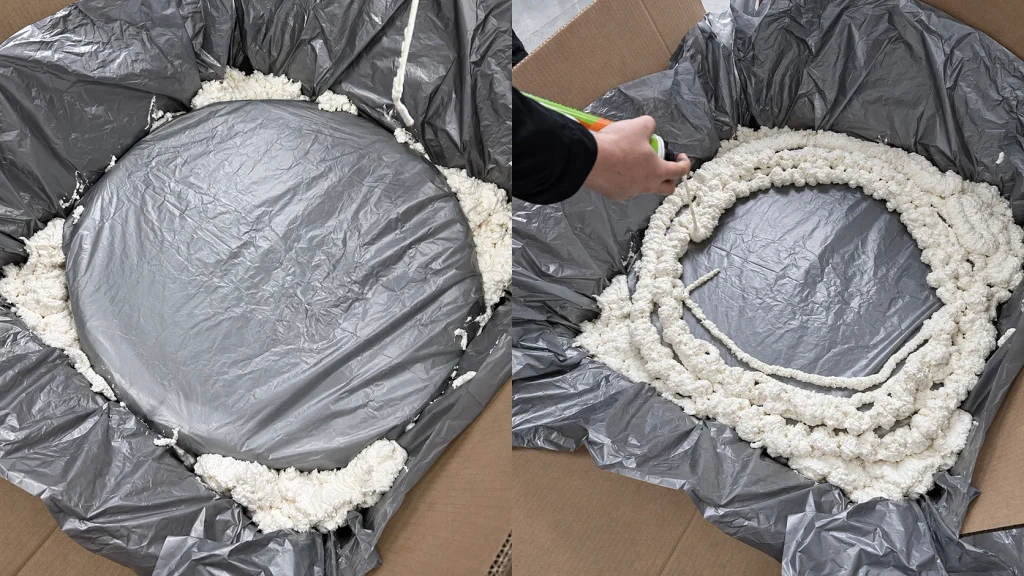 Foam cushioning being formed around a wrapped wheel inside a carton