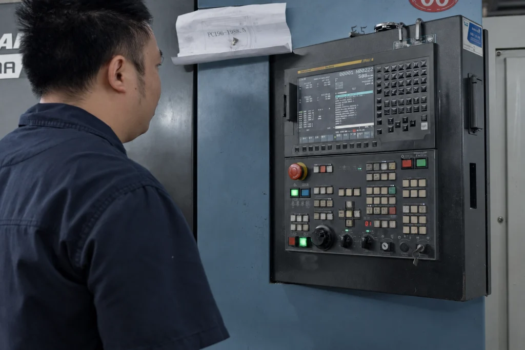 CNC machine operator at the control panel